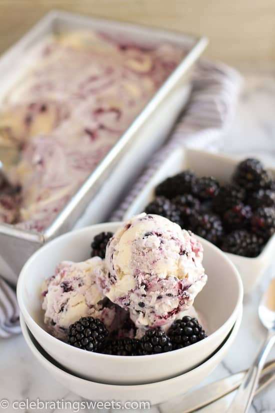 Blackberry vanilla ice cream in a white bowl garnished with blackberries. 