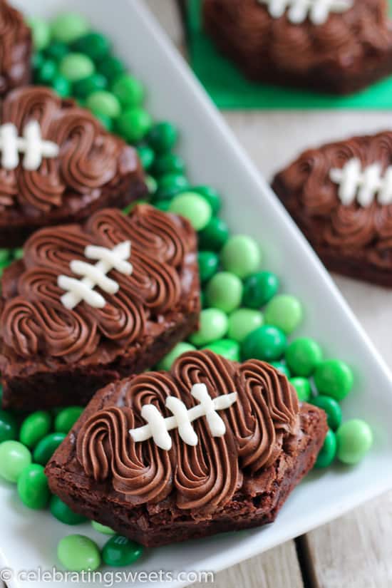 Football shaped brownies on top of green M&M\'s.