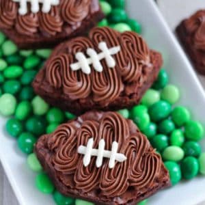 Football shaped brownies on top of green M&M's.