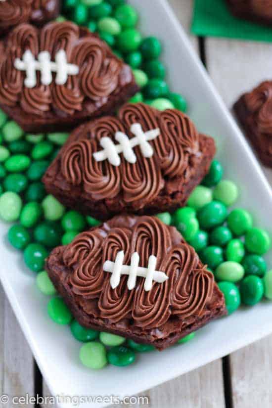 Football shaped brownies on top of green M&M\'s.