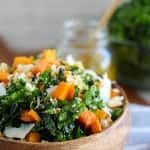Kale and sweet potato salad in a wooden bowl.
