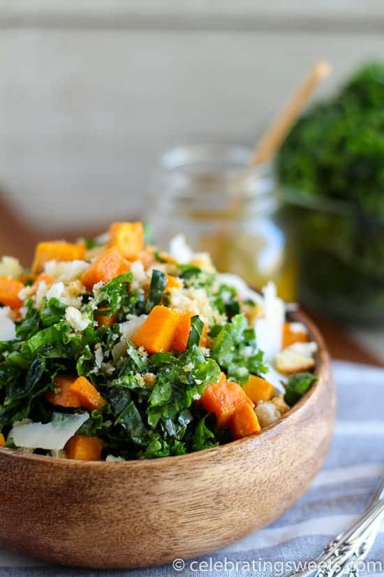 Kale and sweet potato salad in a wooden bowl.