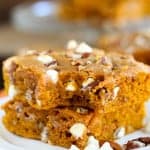 Stack of pumpkin bars on a white plate.