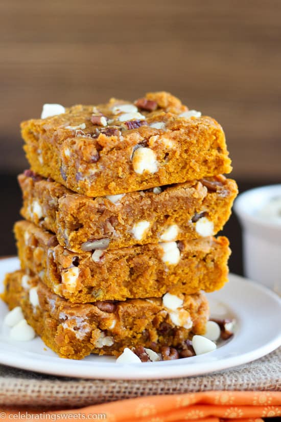 Stack of pumpkin bars on a white plate.