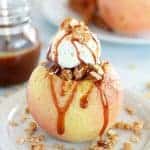 Baked Apple topped with ice cream and caramel sauce.