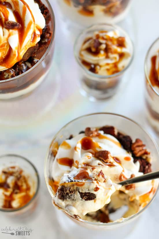 Brownie trifles in a glass dish topped with caramel.