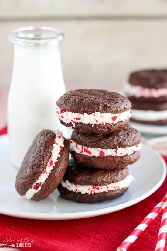 Stack of peppermint sandwich cookies with milk in the background.