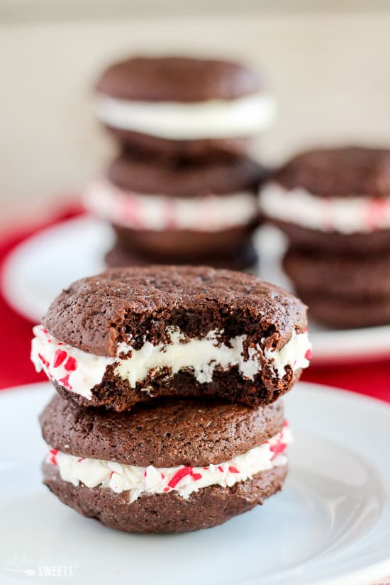 Stack of peppermint sandwich cookies on a white plate.