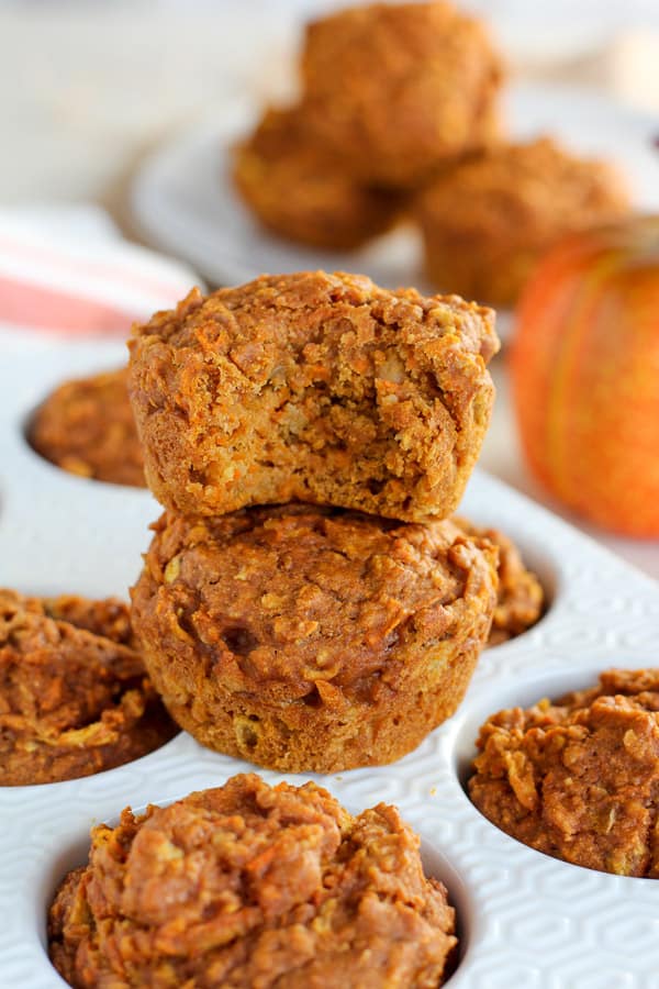 Two pumpkin muffins stacked on top of each other. 