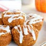 Healthy Pumpkin Muffins ona white plate with a pumpkin in the background.