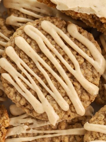 Pile of oatmeal cookies topped with brown maple icing.