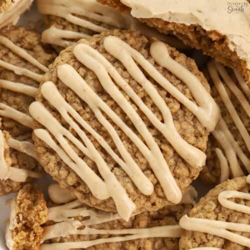Pile of oatmeal cookies topped with brown maple icing.