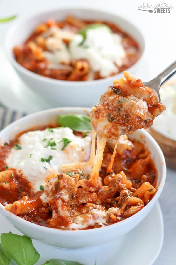 Lasagna Soup in a white bowl with melted cheese