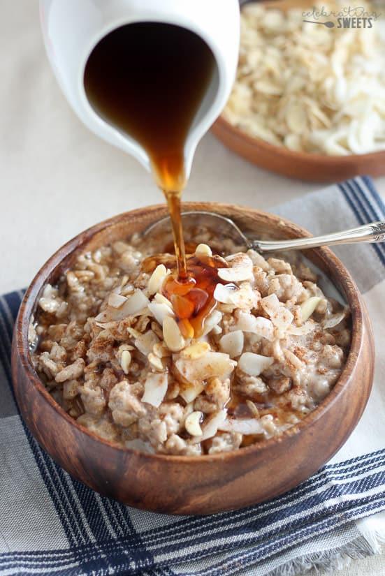 Bowl of oatmeal topped with coconut and almonds. 