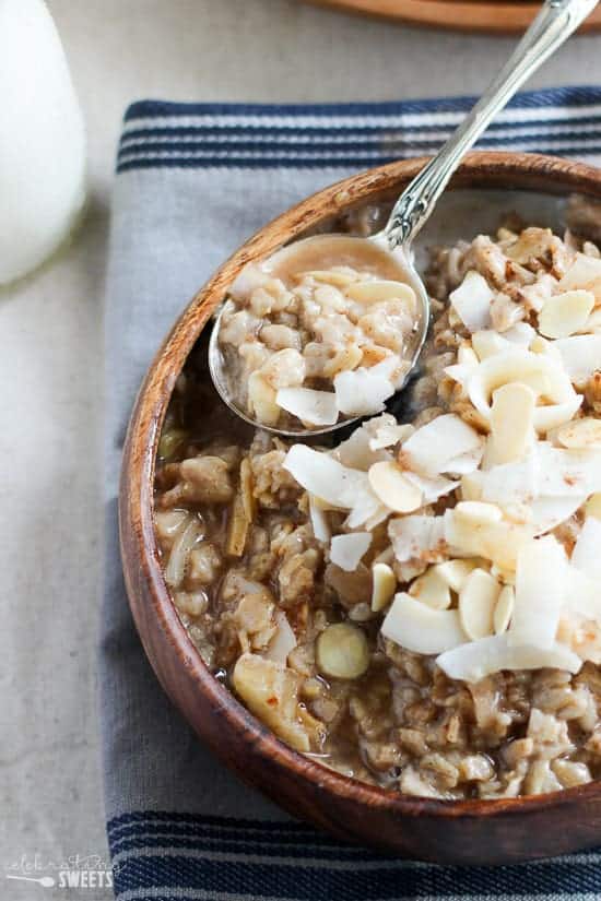 Bowl of oatmeal topped with coconut and almonds. 