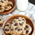 Oatmeal raisin cookies on a wooden plate.