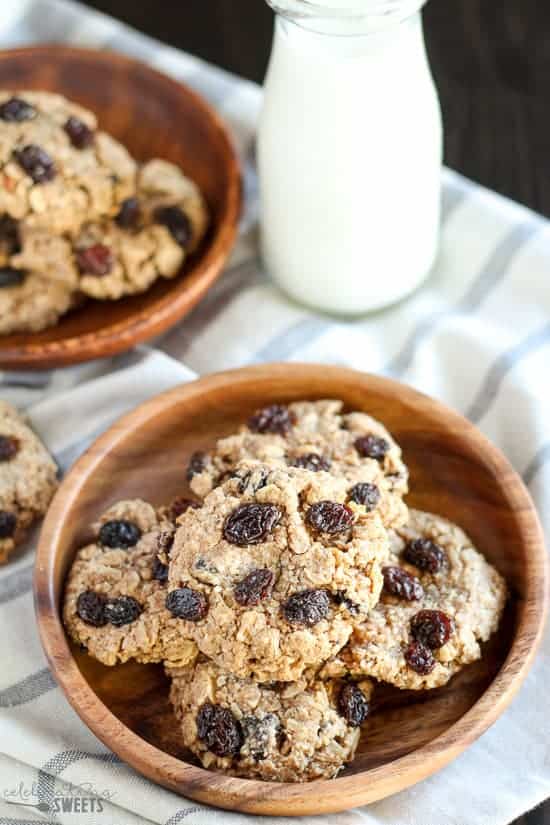 Oatmeal raisin cookies on a wooden plate.