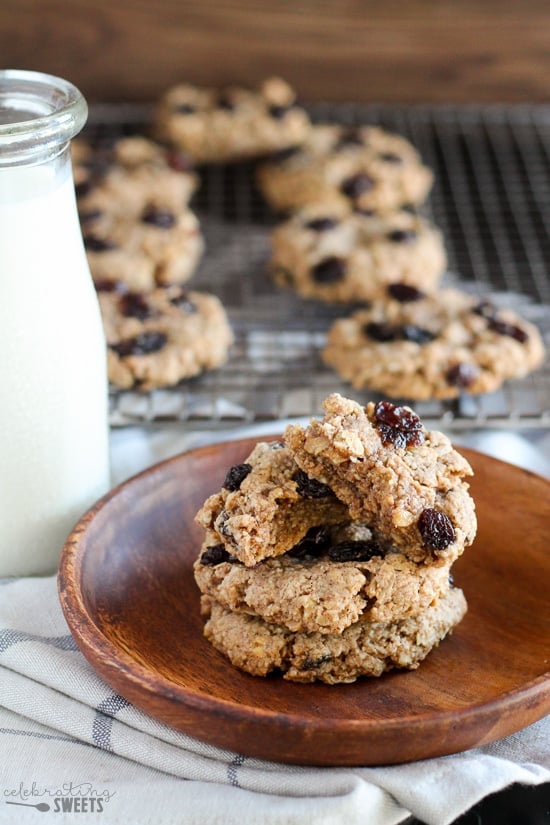 Oatmeal raisin cookies on a wooden plate.