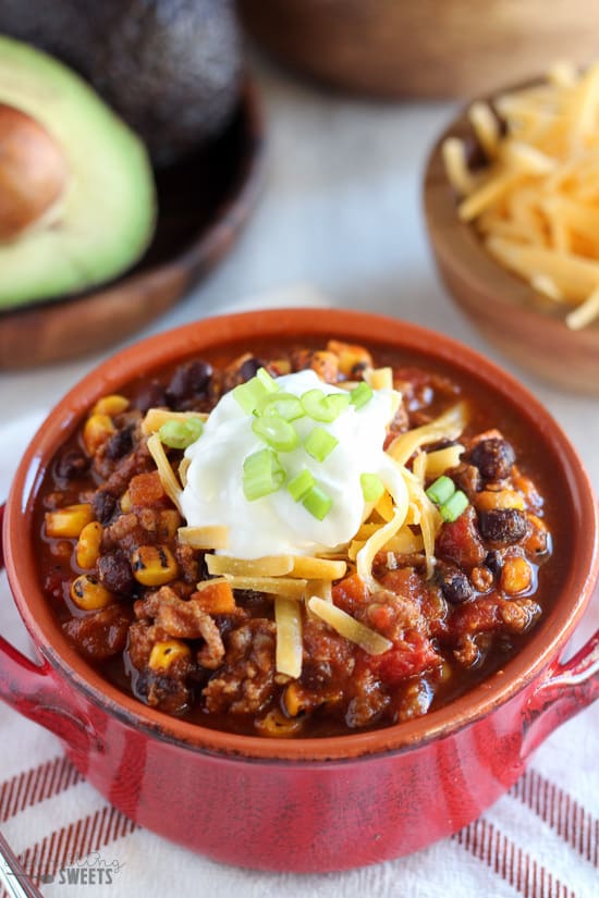 Taco soup in a red bowl with sour cream.