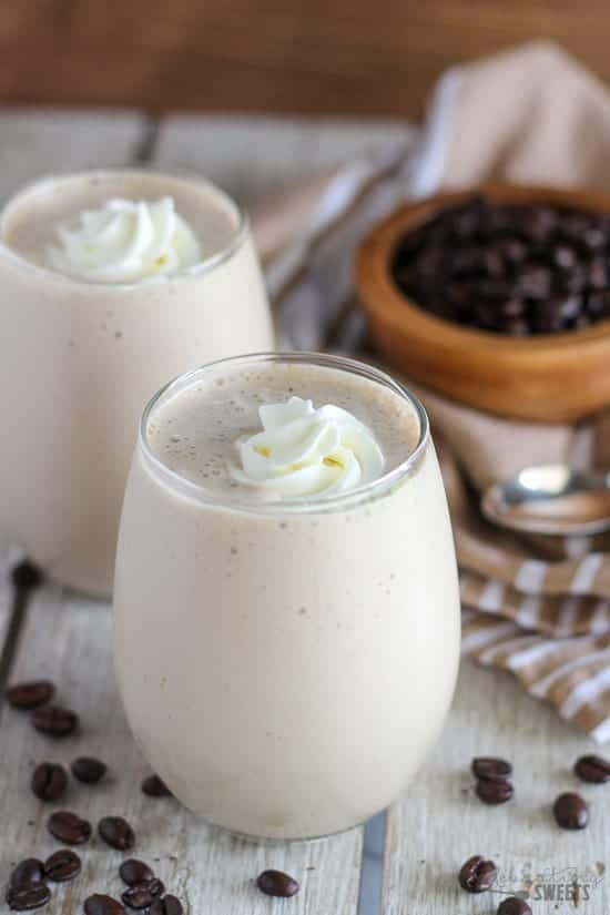 Coffee smoothie in a glass topped with whipped cream.