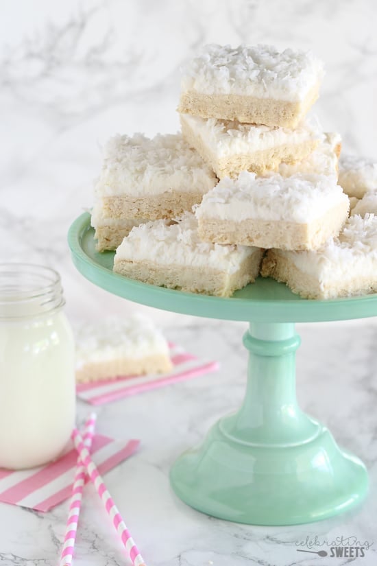 Stack of sugar cookie bars topped with coconut.