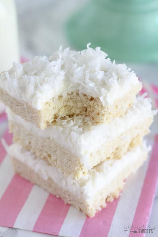 Stack of sugar cookie bars topped with coconut.