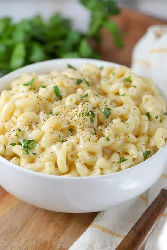 Bowl of macaroni and cheese in a white bowl. 