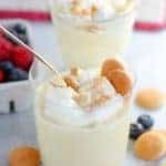 Vanilla pudding in a glass with vanilla wafer cookies.