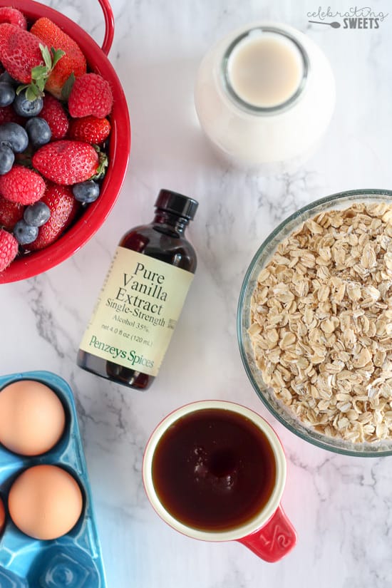 Bowl of oats, vanilla, strawberries, and syrup.