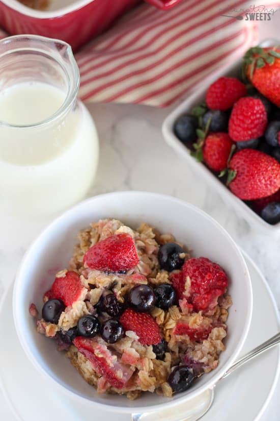 A bowl of oatmeal topped with berries.