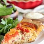 Savory Tomato Cheddar Pie - A buttermilk biscuit crust holds layers of freshly sliced tomatoes, cheddar and parmesan cheeses, and a creamy dill and scallion filling. This flavorful savory pie can be served for any meal of the day.