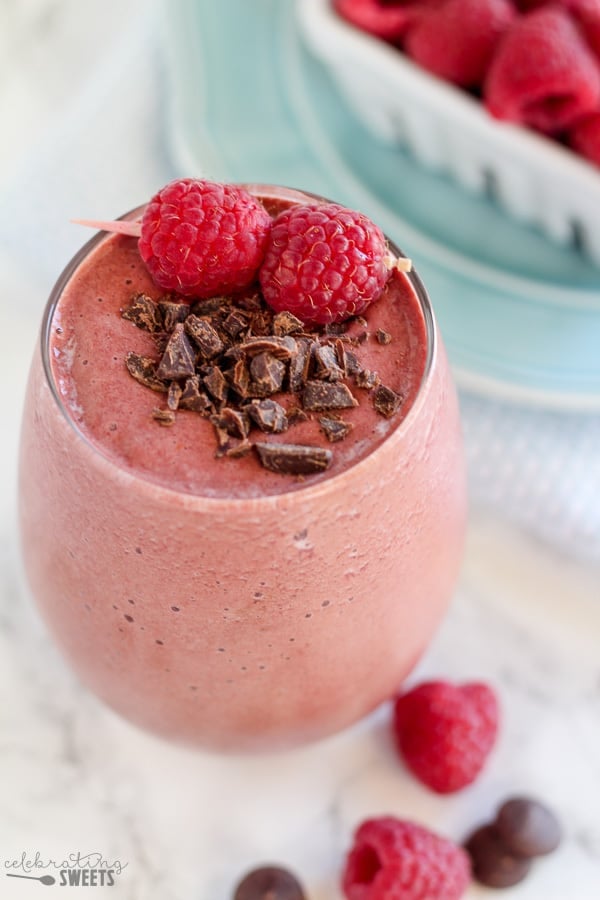 Chocolate smoothie topped with raspberries. 