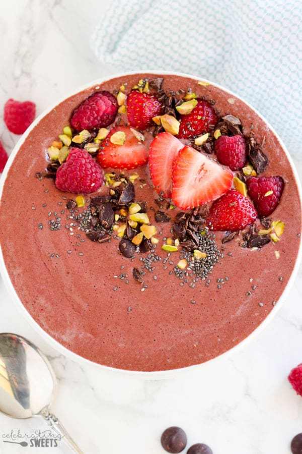 Chocolate smoothie topped with berries. 