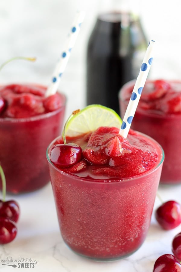 Cherry daiquiri garnished with cherries and lime. 