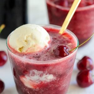 Cherry daiquiri topped with a scoop of vanilla ice cream.