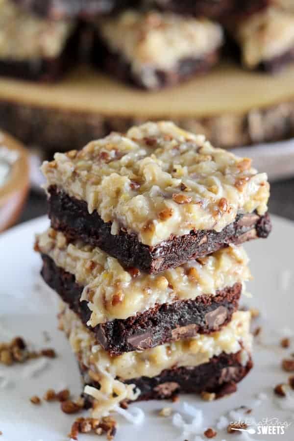 Stack of brownies with coconut frosting. 