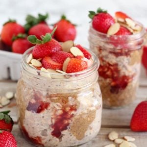 Overnight oats in a jar with strawberries and almond butter.