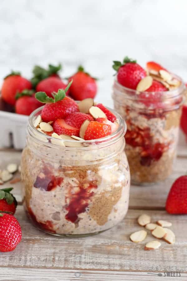 Overnight oats in a jar with strawberries and almond butter. 
