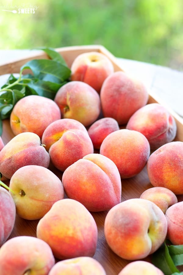 Peaches on a wood tray.