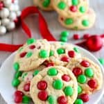 Red and Green Holiday M&M Christmas Cookies on a White Plate with Red Ribbon