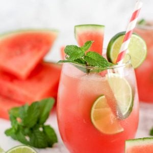 Watermelon mojito garnished with lime and mint.