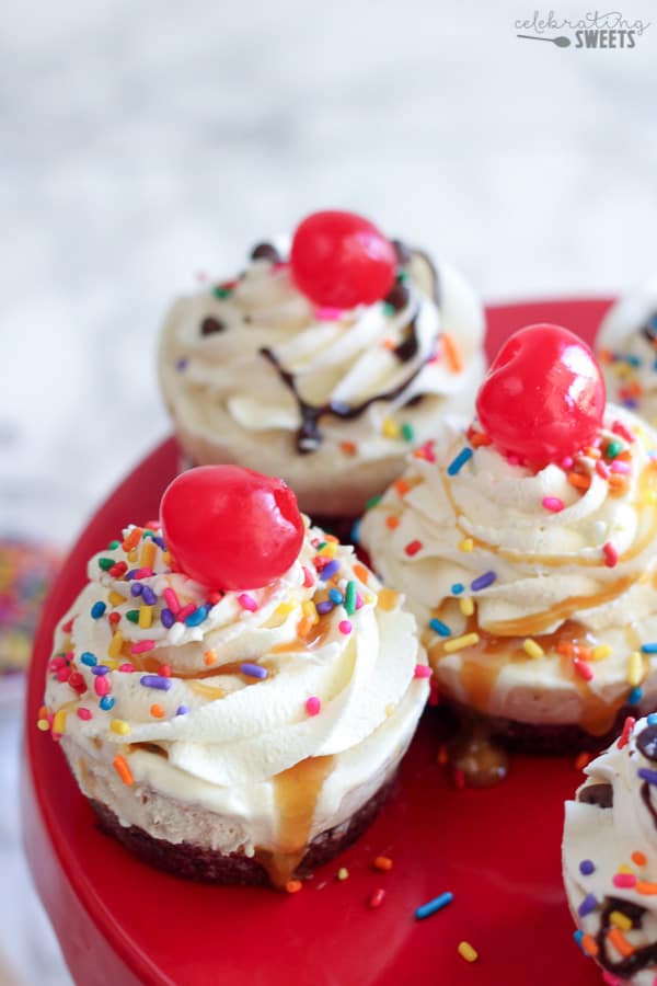 Ice cream cupcakes topped with whipped cream and sprinkles.