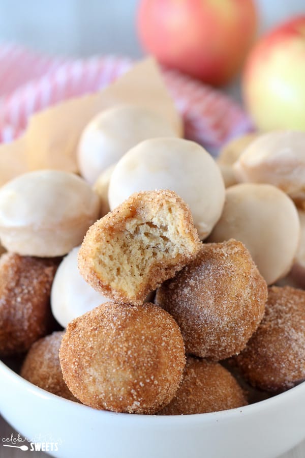Donut holes with cinnamon sugar and icing in a bowl.