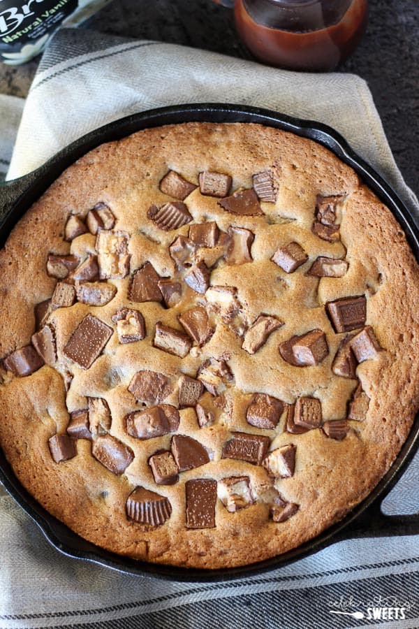 Skillet cookie topped with chopped candy bars.