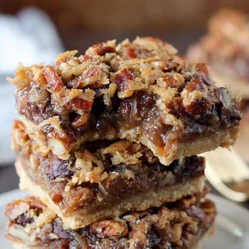 Stack of pecan pie bars with chocolate and coconut