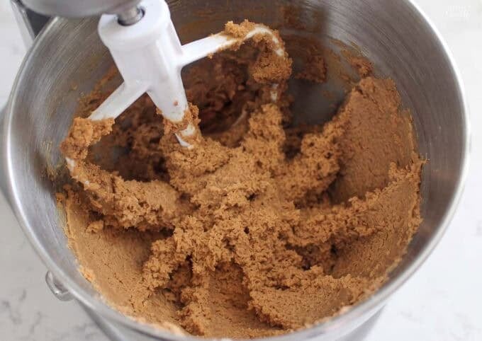 Chai cookie dough in a mixing bowl with a beater.