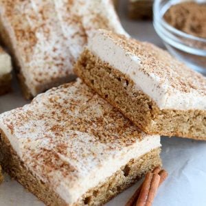 Cookie bars topped with frosting and cinnamon sugar.