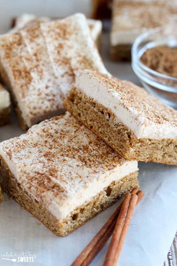 Cookie bars topped with frosting and cinnamon sugar.