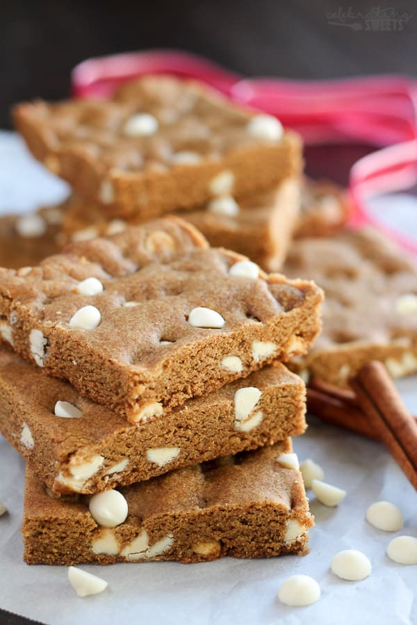 Stack of gingerbread cookie bars filled with white chocolate chips.