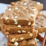 Stack of gingerbread cookie bars filled with white chocolate chips.